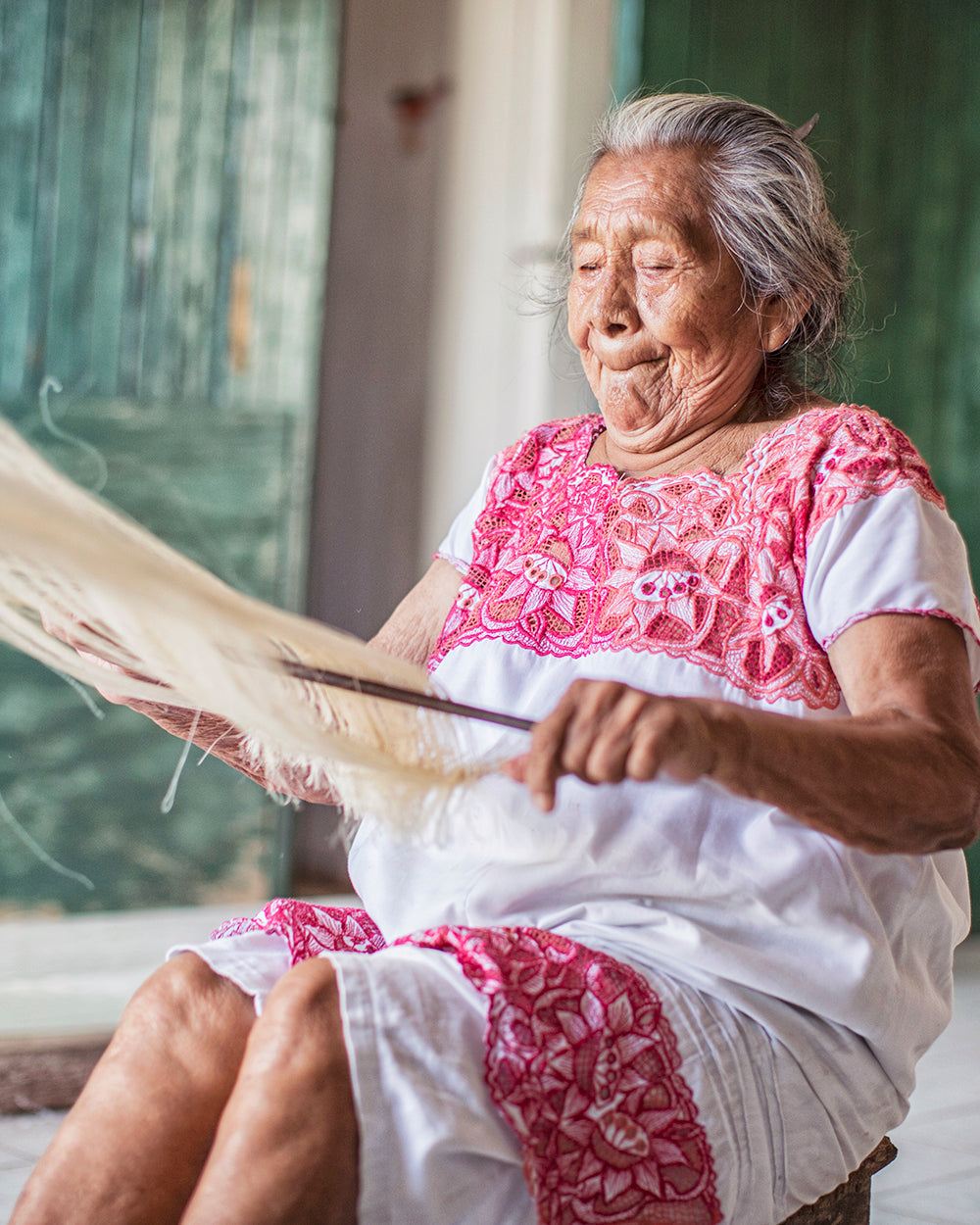 An artisan weaving the sansevieria fibers into textile in Mexico.