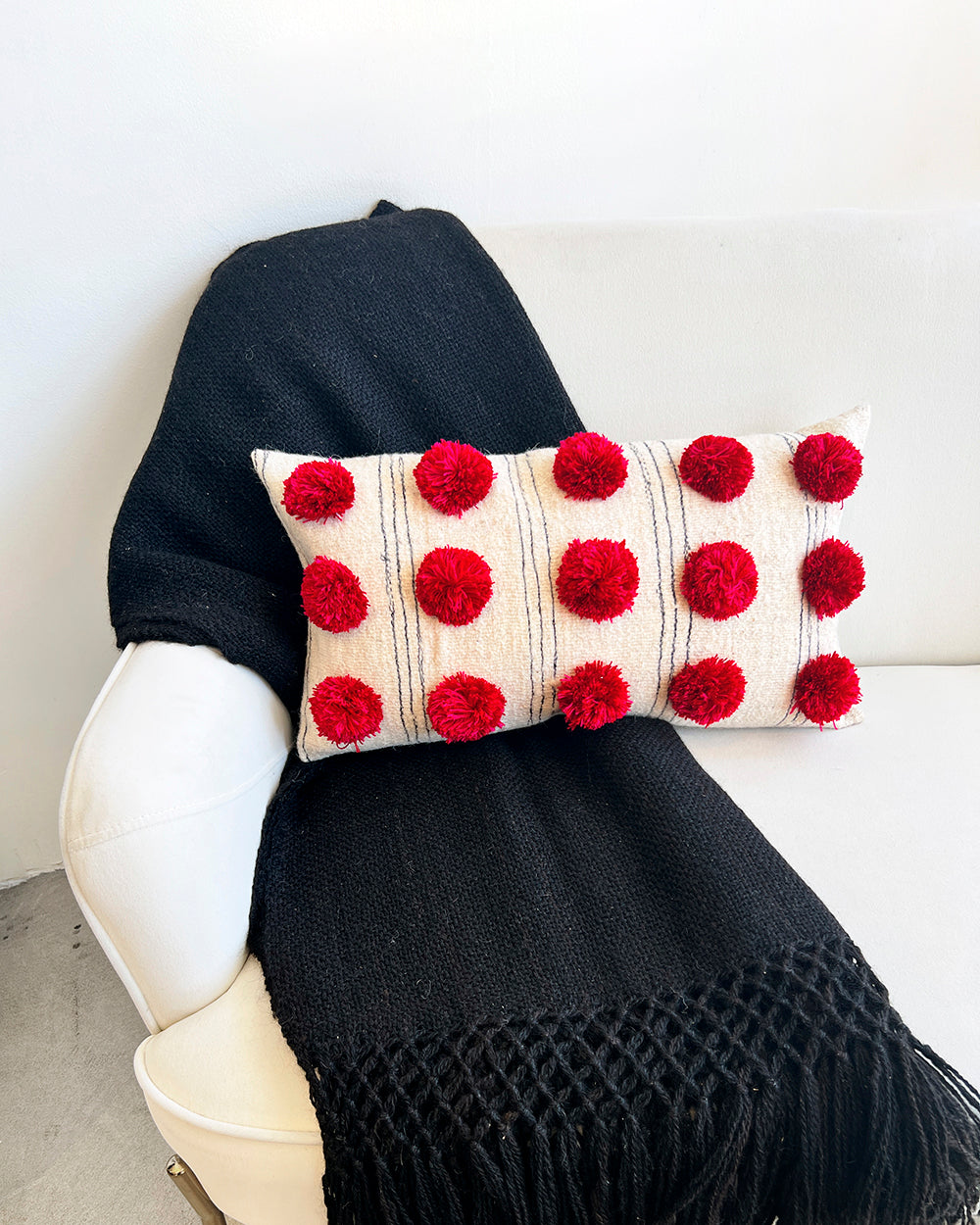 Red pom pom online throw