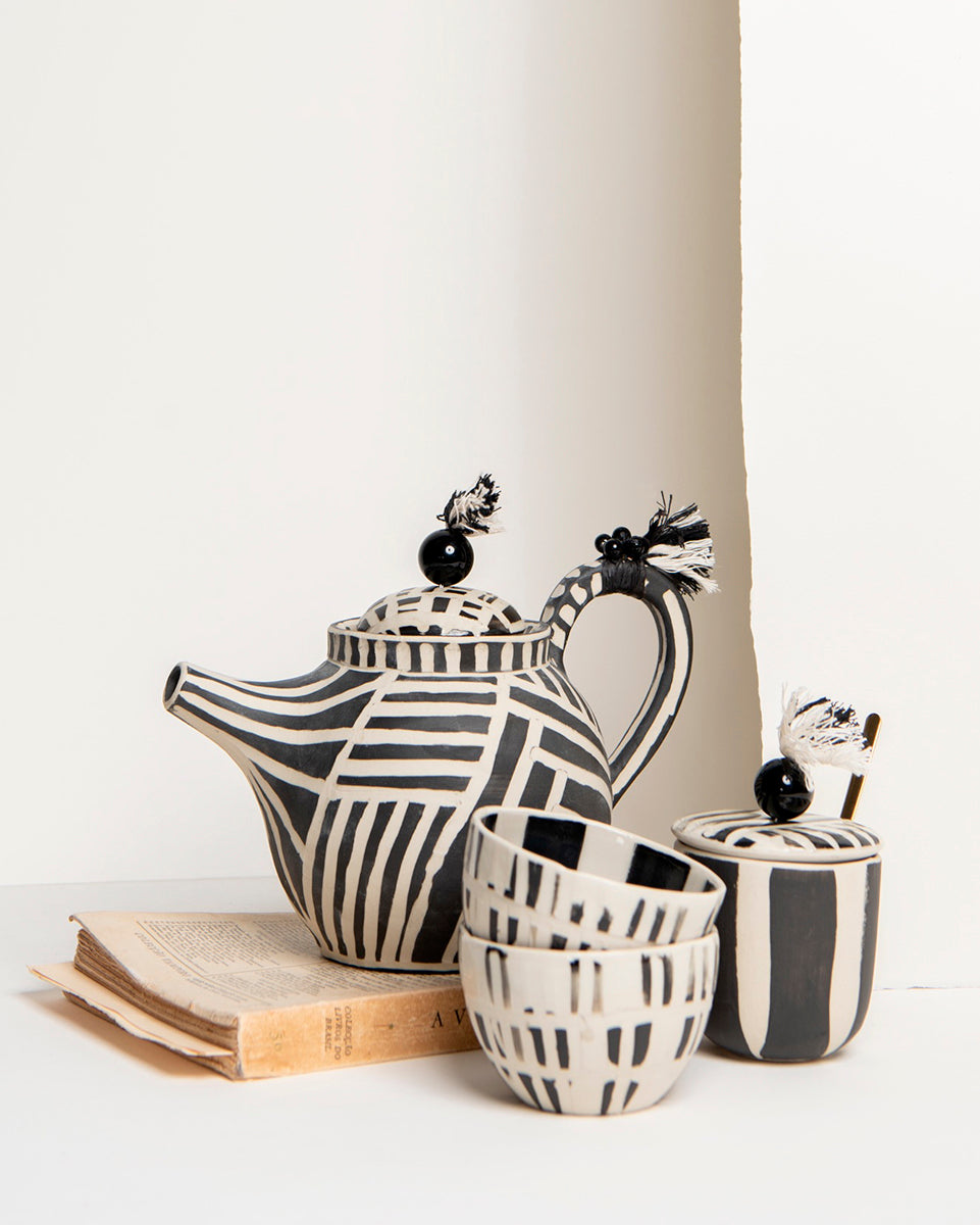 The striped teapot, teacups, and sugar-bowl with spoon
