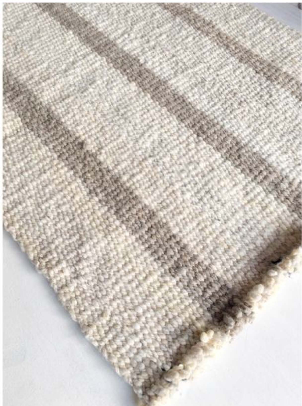 Handwoven wool rug beige and white