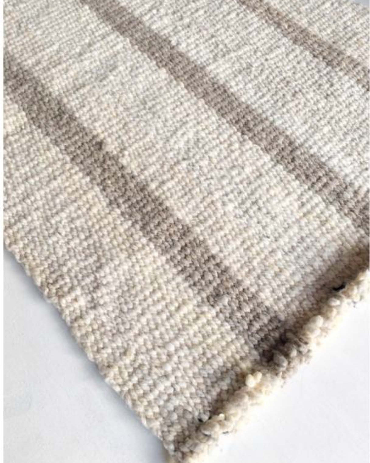 Handwoven wool rug beige and white