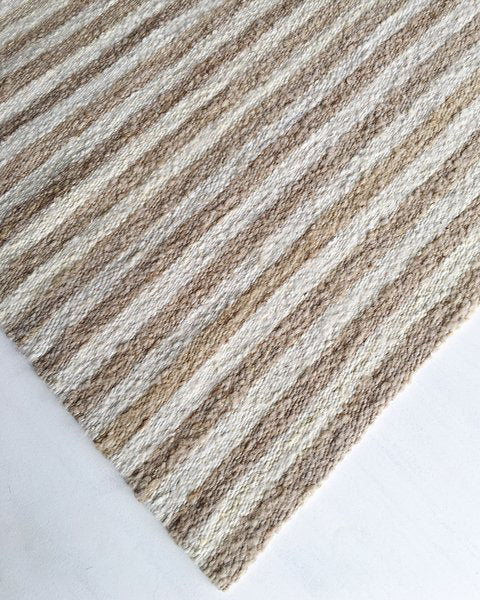 Handwoven wool rug beige and white