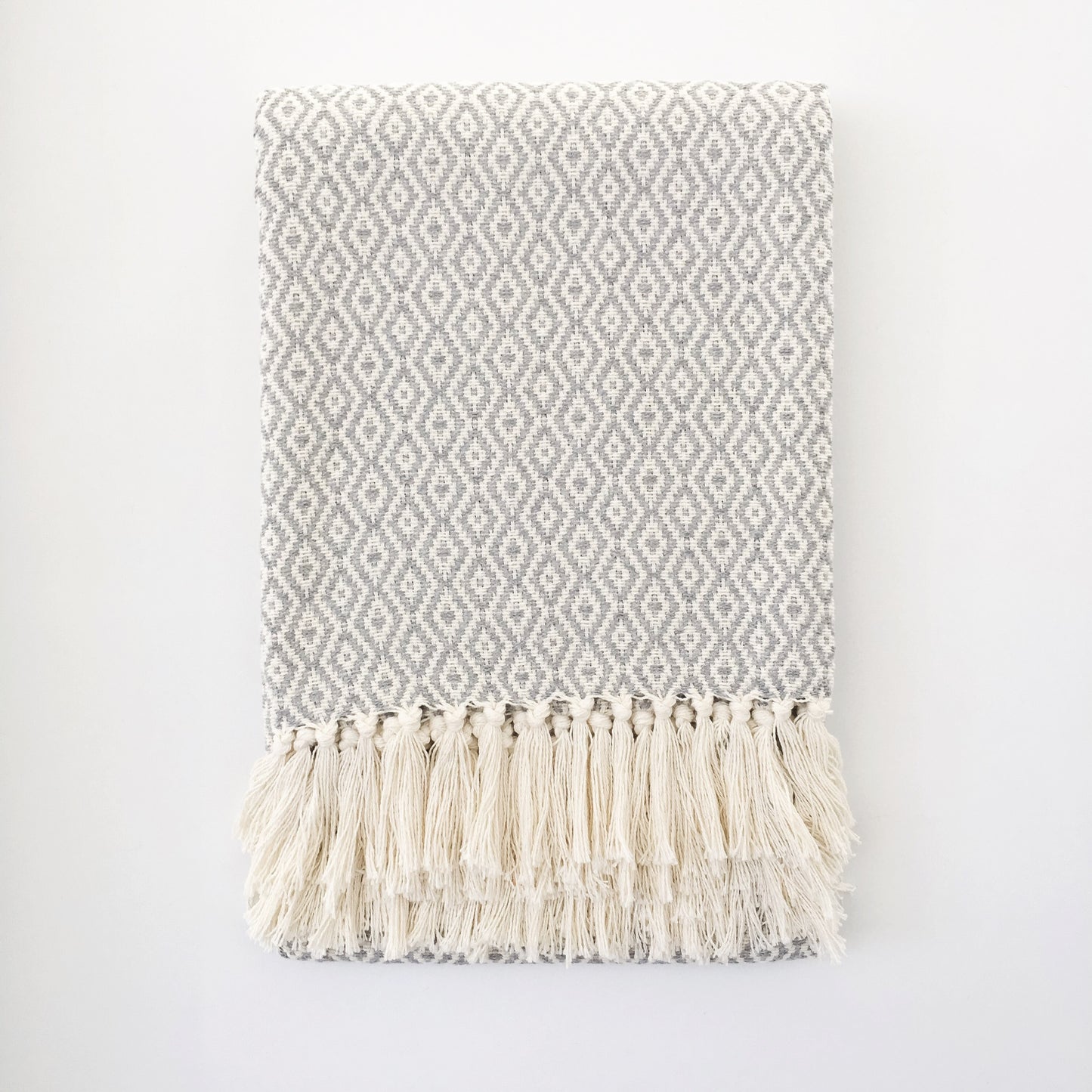 Handwoven recycled cotton throw geometric pattern grey and white fringe