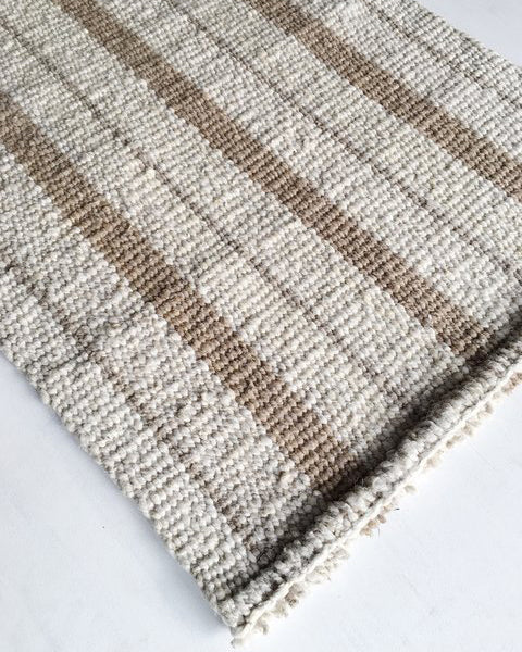Handwoven wool rug beige and white